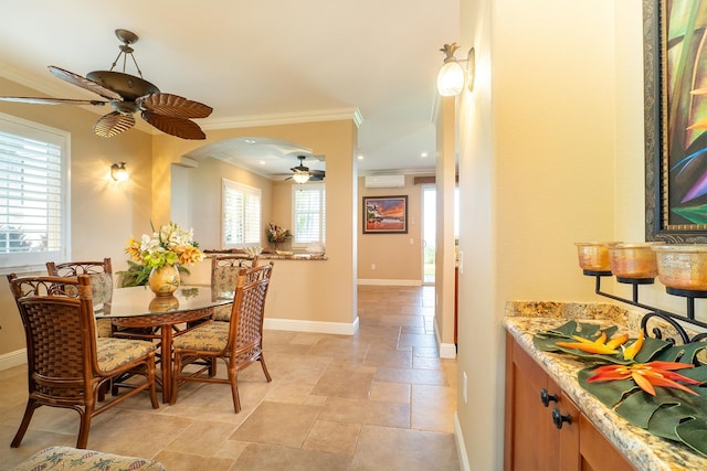 dining room with an AC wall unit and ornamental molding