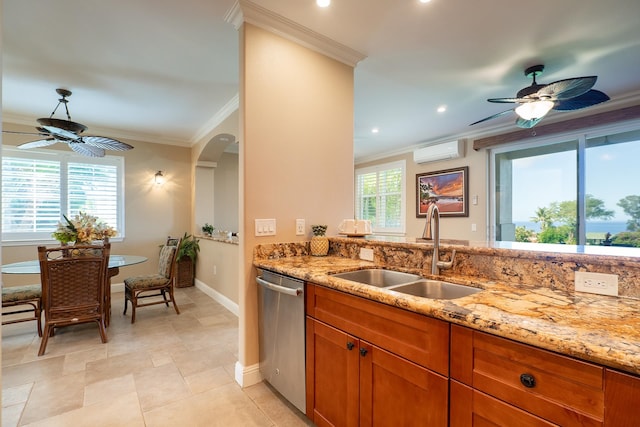 kitchen featuring a healthy amount of sunlight, stainless steel dishwasher, sink, and light stone countertops