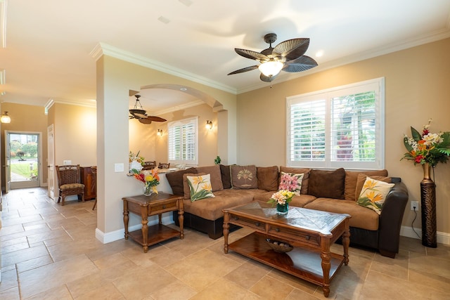 living room featuring ceiling fan, a wealth of natural light, and ornamental molding