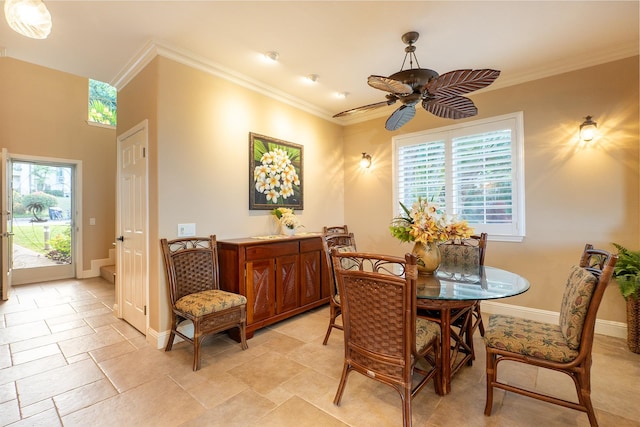 dining space featuring ceiling fan and crown molding