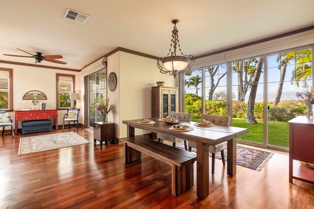 dining space with ceiling fan, wood-type flooring, and crown molding