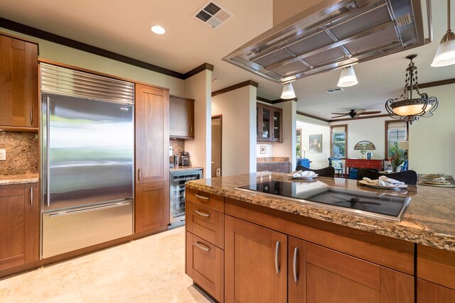 kitchen with wine cooler, built in refrigerator, decorative backsplash, black electric cooktop, and island range hood