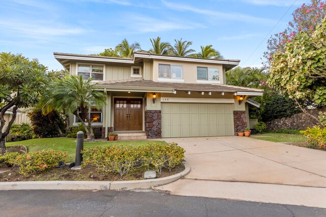 view of front of home with a garage and a front lawn