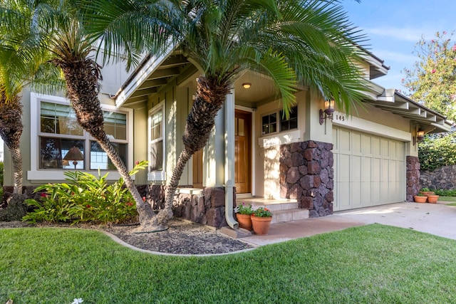 view of exterior entry with a yard