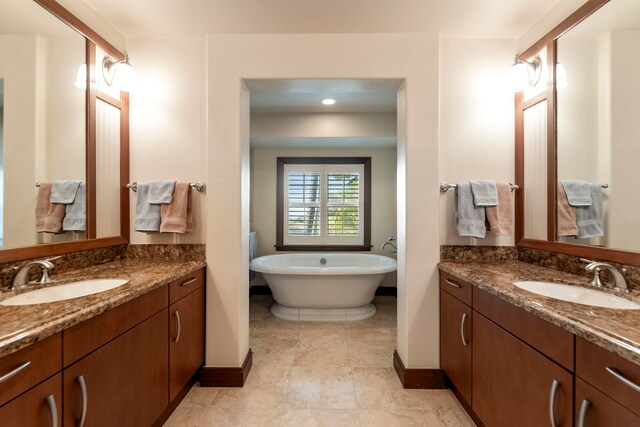 bathroom featuring a washtub and vanity