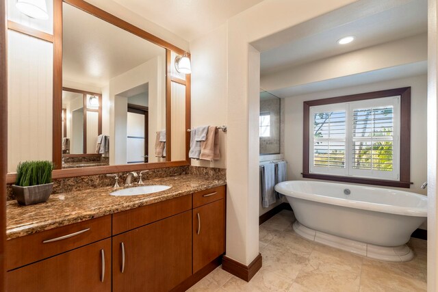 bathroom with a bathing tub and vanity