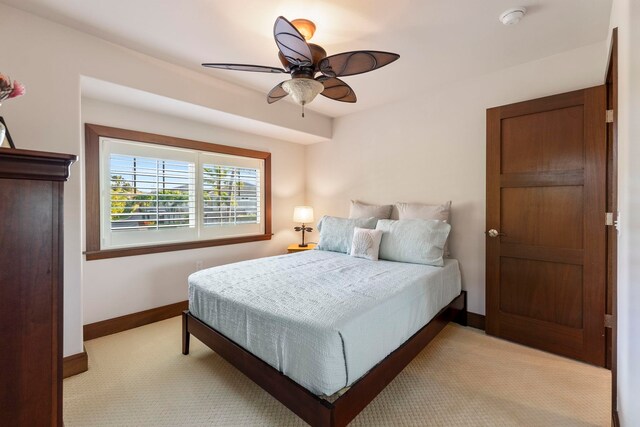 bedroom featuring ceiling fan and light colored carpet