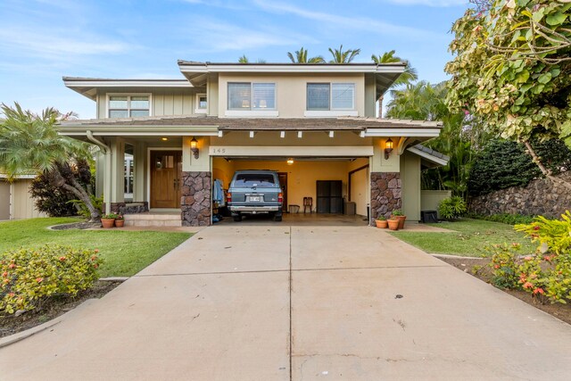 view of front of house featuring a front yard and a garage