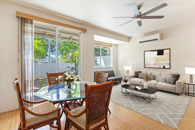 31 E Kuu Aku Ln Unit 206, Lahaina, HI 96761 - dining space featuring a wall mounted AC, wood finished floors, and ceiling fan