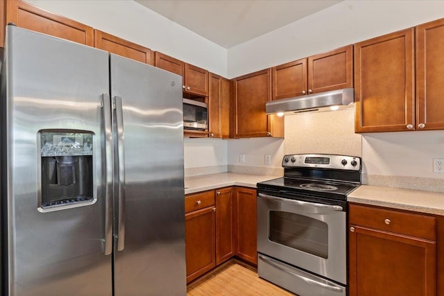 31 E Kuu Aku Ln Unit 206, Lahaina, HI 96761 - kitchen featuring appliances with stainless steel finishes, under cabinet range hood, light countertops, and brown cabinetry