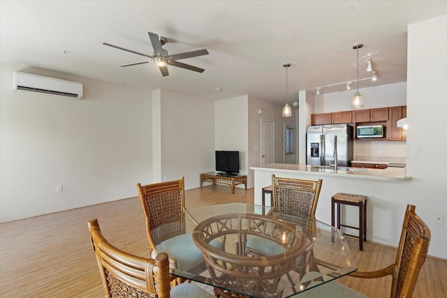 31 E Kuu Aku Ln Unit 206, Lahaina, HI 96761 - dining area featuring a wall mounted AC and a ceiling fan