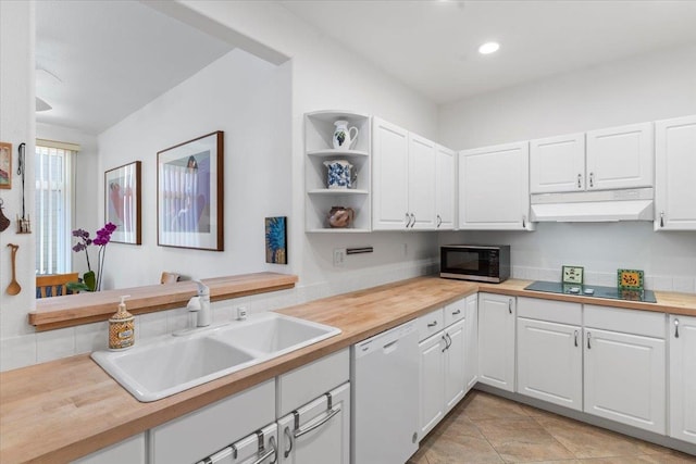 kitchen featuring black appliances, under cabinet range hood, white cabinetry, and a sink