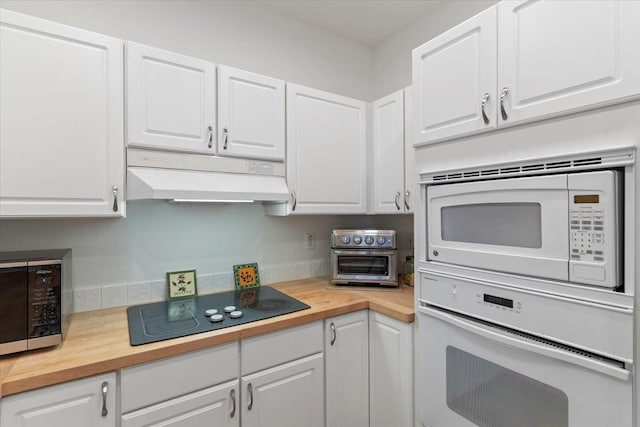 kitchen with black appliances, butcher block countertops, white cabinets, and under cabinet range hood