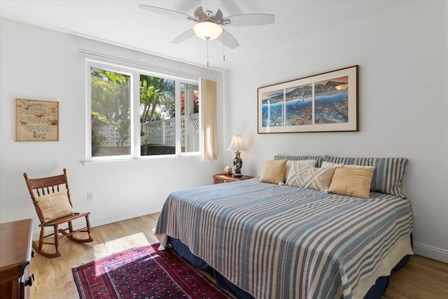 bedroom featuring ceiling fan, wood finished floors, and baseboards