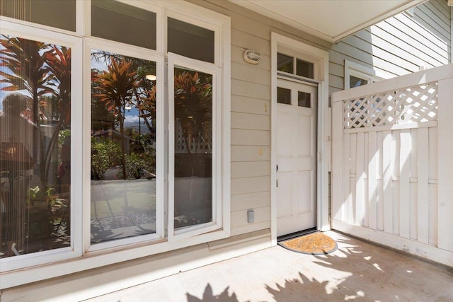 view of exterior entry featuring fence