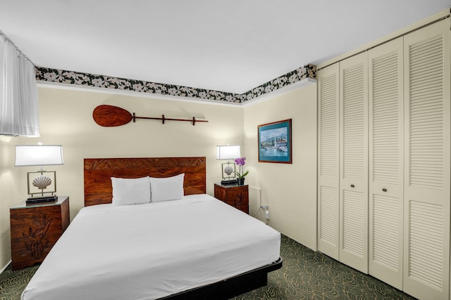 bedroom featuring a closet and dark colored carpet