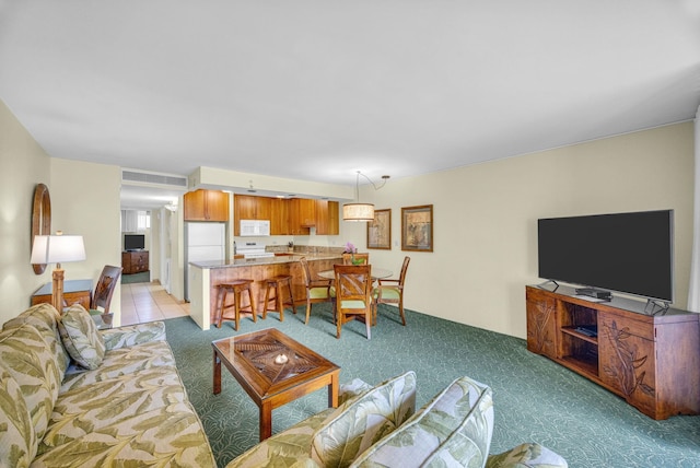 living room featuring light carpet and visible vents