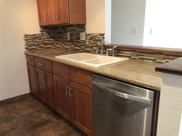 kitchen with sink, decorative backsplash, and dishwasher