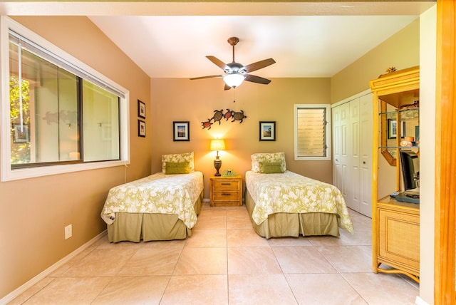 bedroom with tile patterned floors and ceiling fan