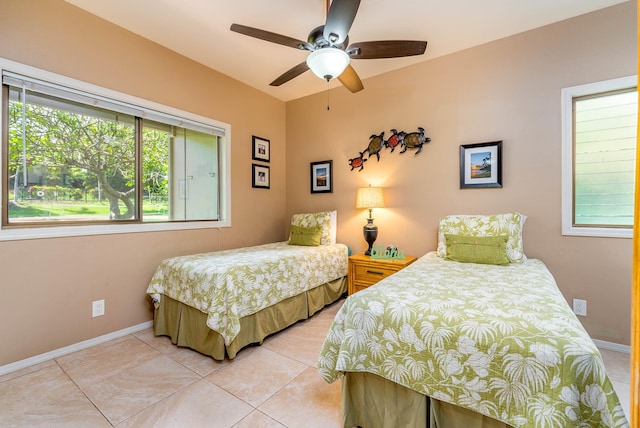 bedroom with light tile patterned floors and ceiling fan