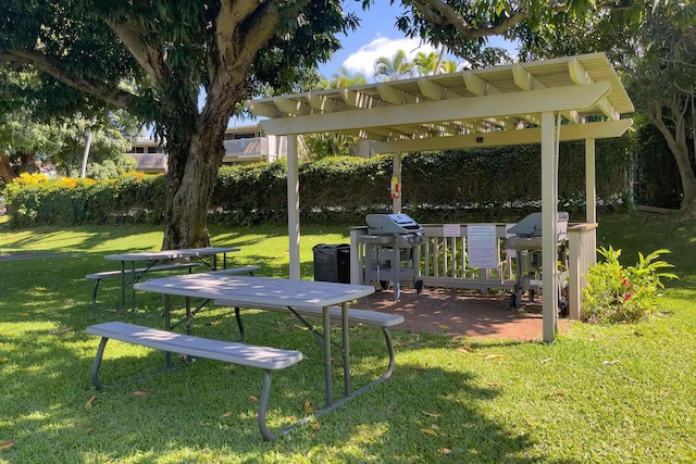 view of property's community featuring a pergola and a lawn