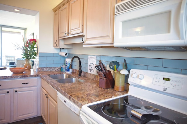 kitchen featuring decorative backsplash, light brown cabinets, white appliances, and sink