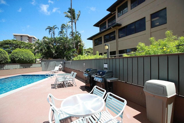 view of swimming pool featuring area for grilling and a patio area