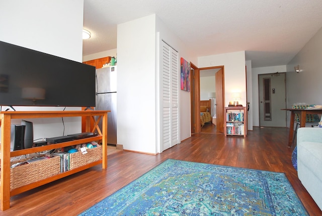 living room featuring hardwood / wood-style floors and a textured ceiling