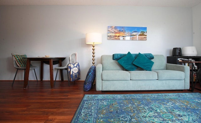 living room with a textured ceiling and dark hardwood / wood-style flooring