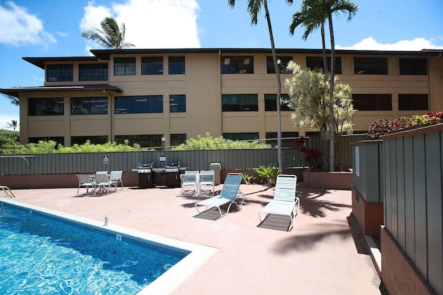 view of swimming pool featuring a grill and a patio area