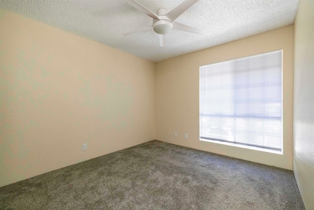carpeted spare room featuring ceiling fan and a textured ceiling