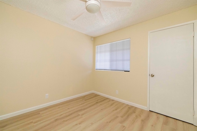 unfurnished room with ceiling fan, a textured ceiling, and light hardwood / wood-style floors