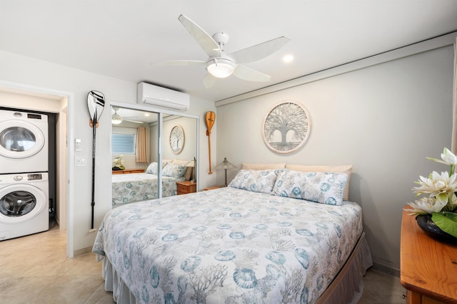 2430 S Kihei Rd Unit 411, Kihei, HI 96753 - bedroom featuring estacked washer and dryer, a wall mounted air conditioner, a closet, and a ceiling fan