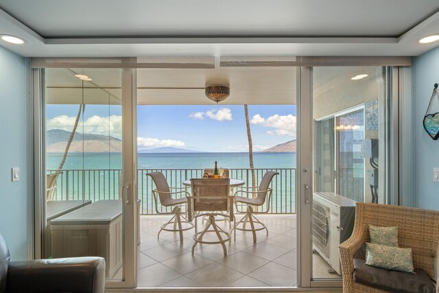 2430 S Kihei Rd Unit 411, Kihei, HI 96753 - sunroom / solarium featuring a water view, tile patterned flooring, healthy amount of natural light, and expansive windows