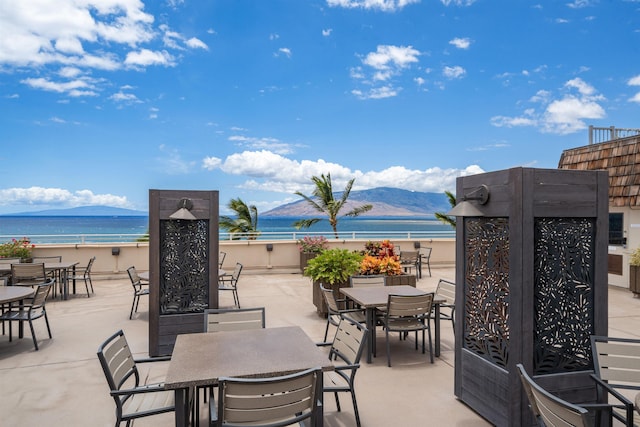 2430 S Kihei Rd Unit 411, Kihei, HI 96753 - view of patio featuring outdoor dining space and a water and mountain view