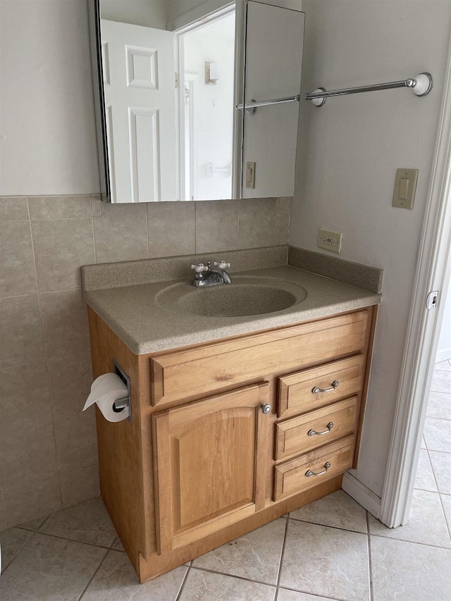 bathroom with tile patterned flooring, vanity, and tile walls