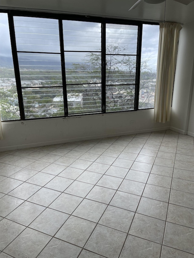 tiled spare room featuring plenty of natural light