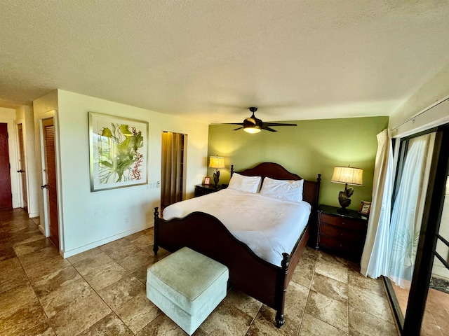 tiled bedroom featuring ceiling fan and a textured ceiling