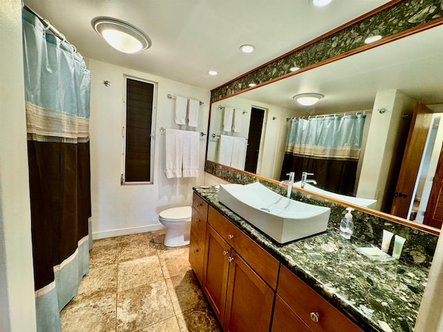 bathroom featuring oversized vanity, toilet, and tile floors