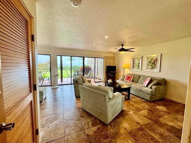 tiled living room with ceiling fan and a textured ceiling