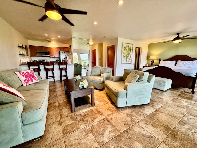 living room with ceiling fan and light tile flooring