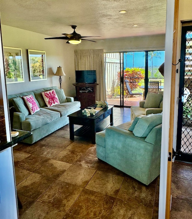 tiled living room with plenty of natural light, a textured ceiling, and ceiling fan