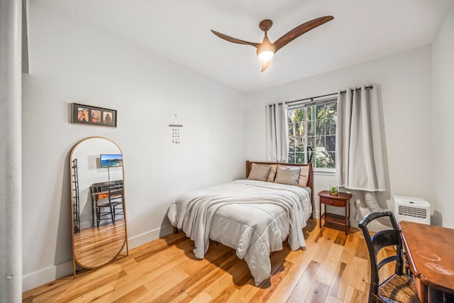 bedroom with light hardwood / wood-style floors and ceiling fan