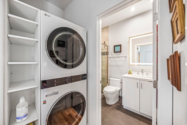 laundry area with light tile patterned flooring, sink, and stacked washer and dryer