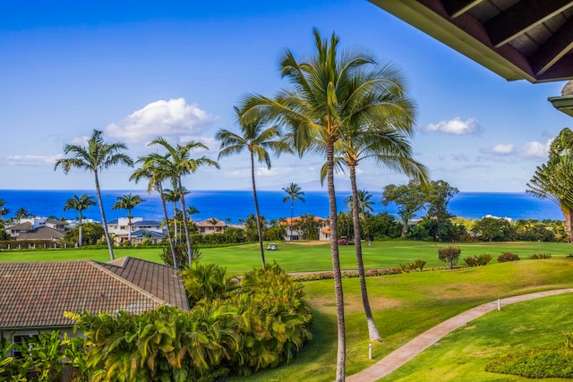 view of home's community with a yard and a water view