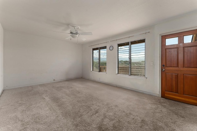 carpeted entryway with ceiling fan