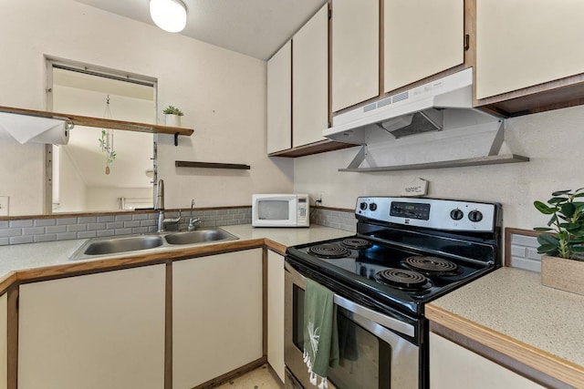 kitchen featuring sink, white cabinets, and electric stove