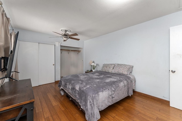 bedroom with ceiling fan and dark wood-type flooring