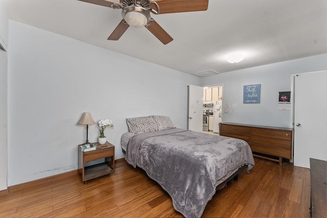 bedroom featuring hardwood / wood-style floors and ceiling fan