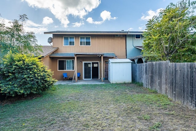 back of house featuring a patio area and a lawn